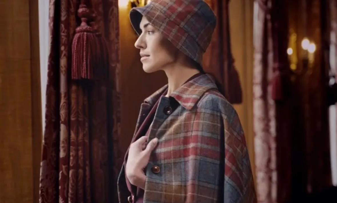 Profile portrait of the plaid wool cape and matching bucket hat