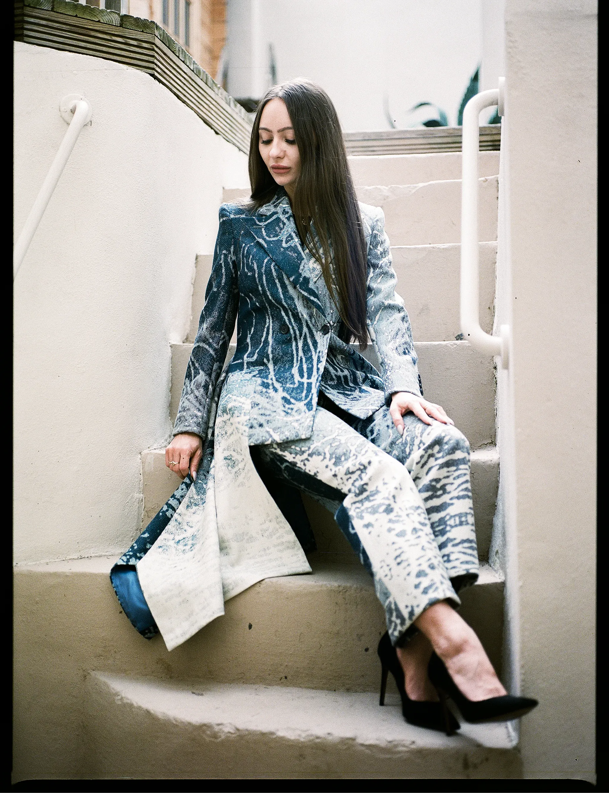Editorial diptych of the blue jacquard suit shot on a staircase