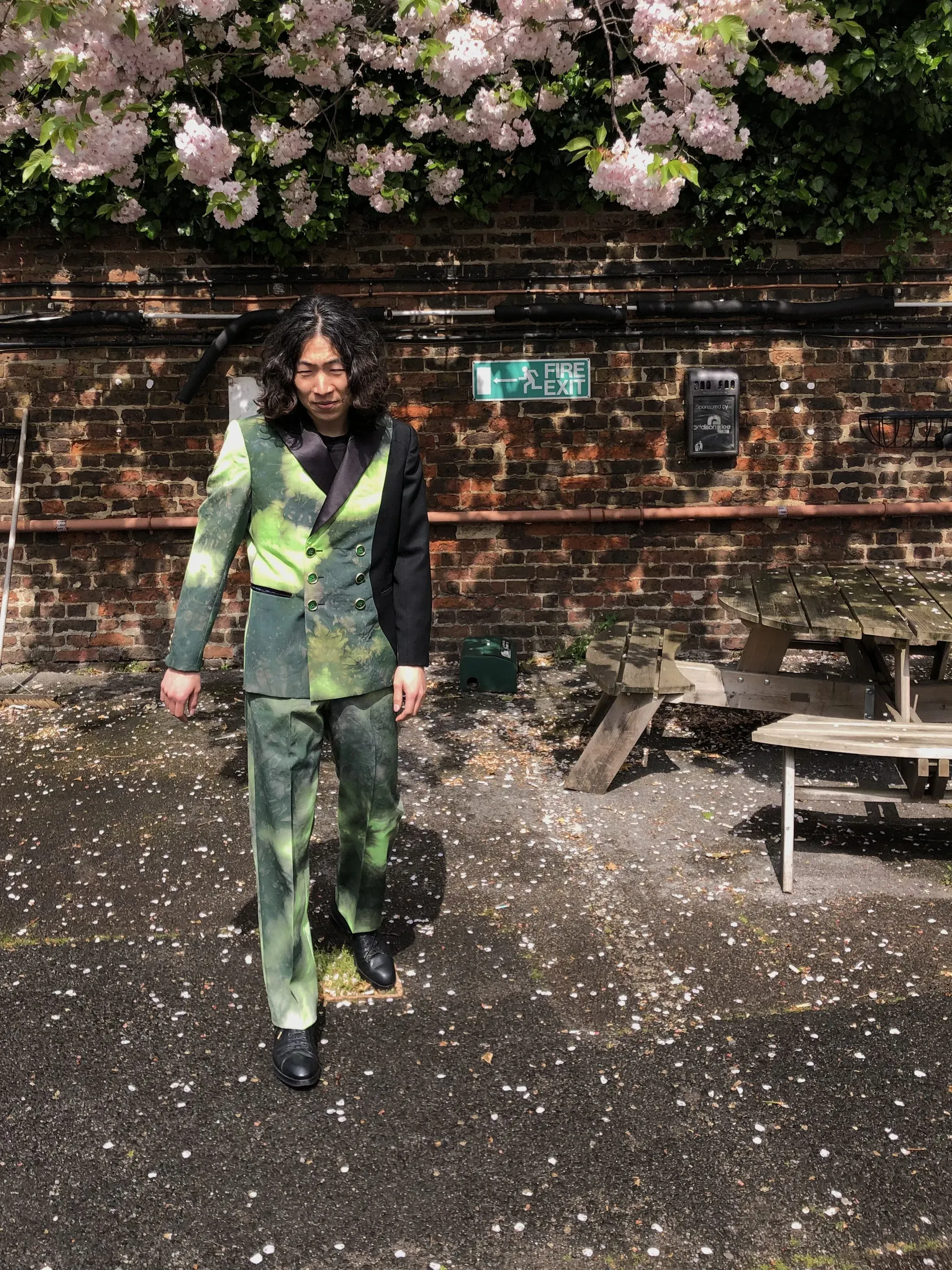 Candid outdoor portrait in the tie-dye green double-breasted jacket