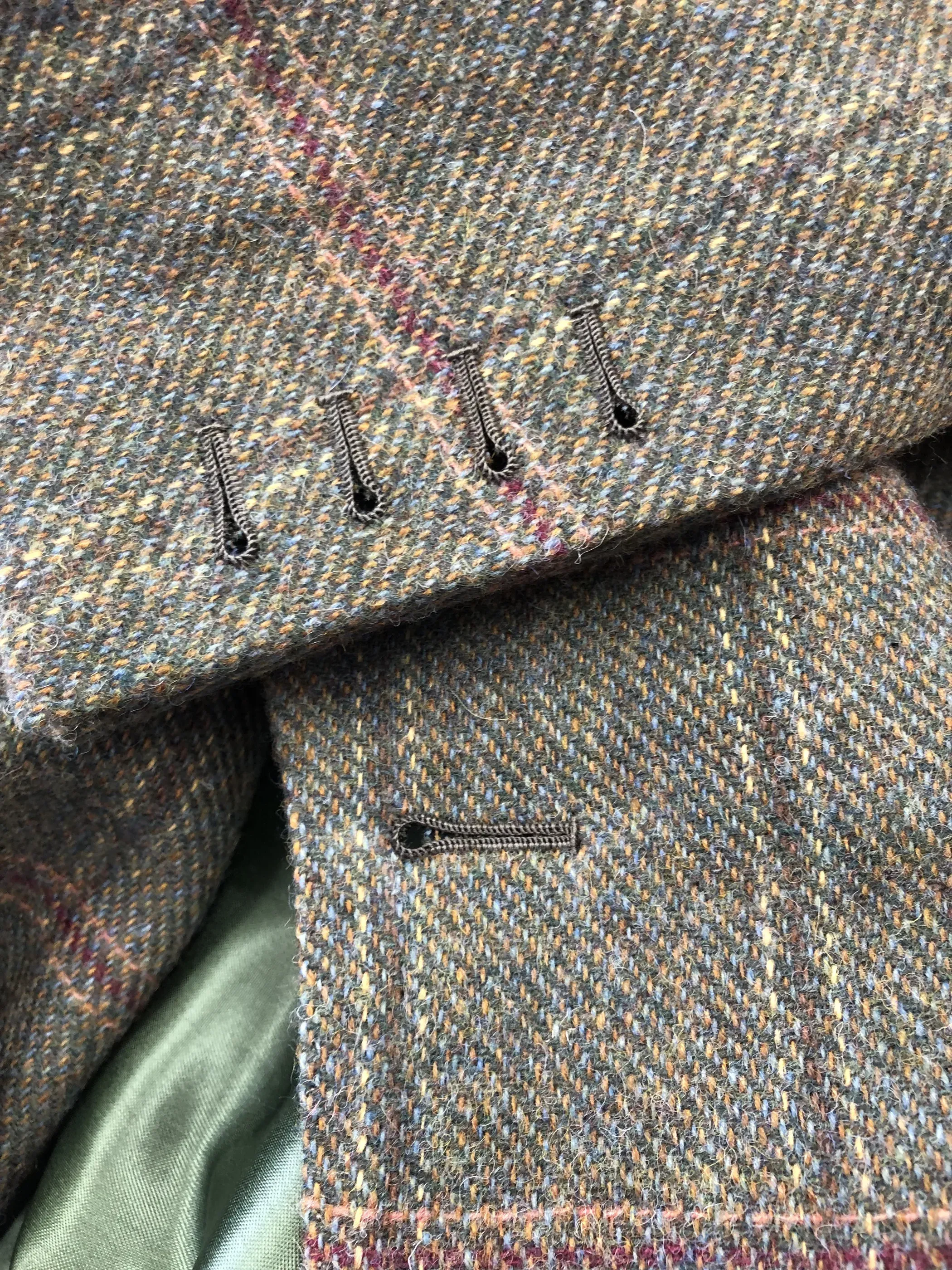 Hand-worked buttonholes on a tweed jacket cuff